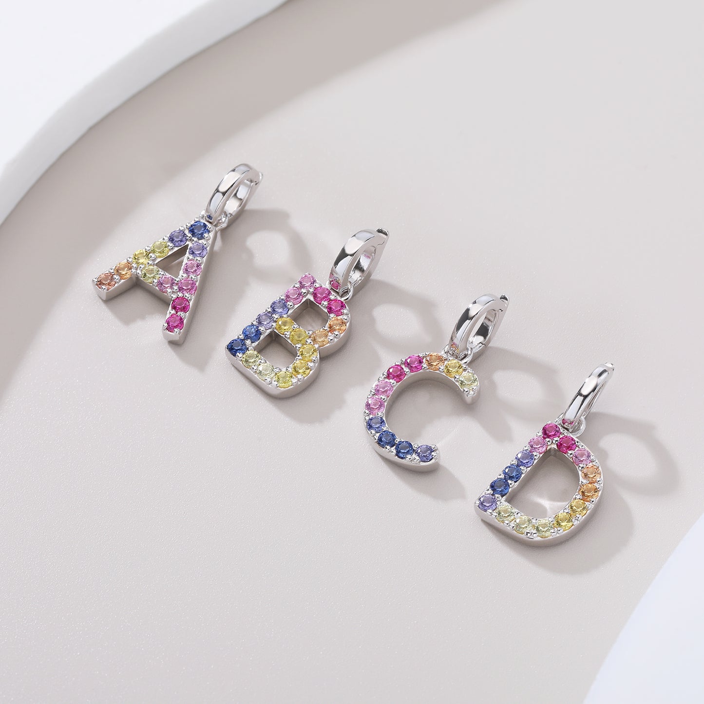 Vibrant multi-color lab-grown sapphire letter A pendant on a sterling silver chain necklace