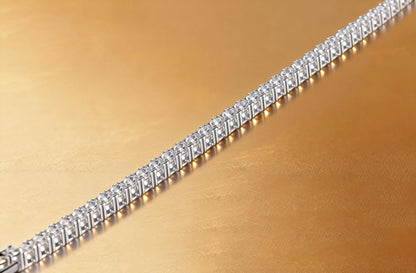 S925 sterling silver tennis bracelet featuring a continuous line of 2.0mm round brilliant white moissanite gemstones with a secure box clasp.