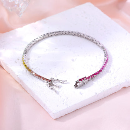 S925 sterling silver tennis bracelet featuring a continuous gradient line of 3.0mm round cut colorful rainbow sapphires with a secure box clasp.