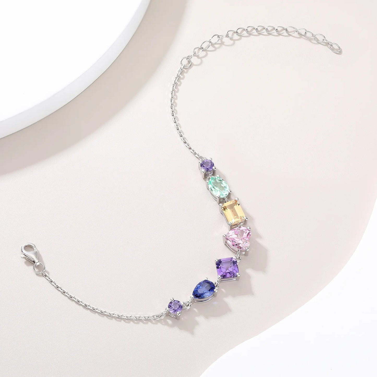 S925 sterling silver chain bracelet featuring seven multi-color and fancy-cut gemstones including heart, pear, emerald, and round shapes.