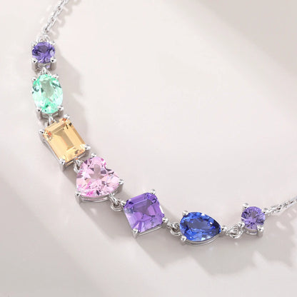 S925 sterling silver chain bracelet featuring seven multi-color and fancy-cut gemstones including heart, pear, emerald, and round shapes.