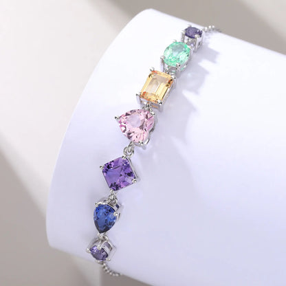 S925 sterling silver chain bracelet featuring seven multi-color and fancy-cut gemstones including heart, pear, emerald, and round shapes.