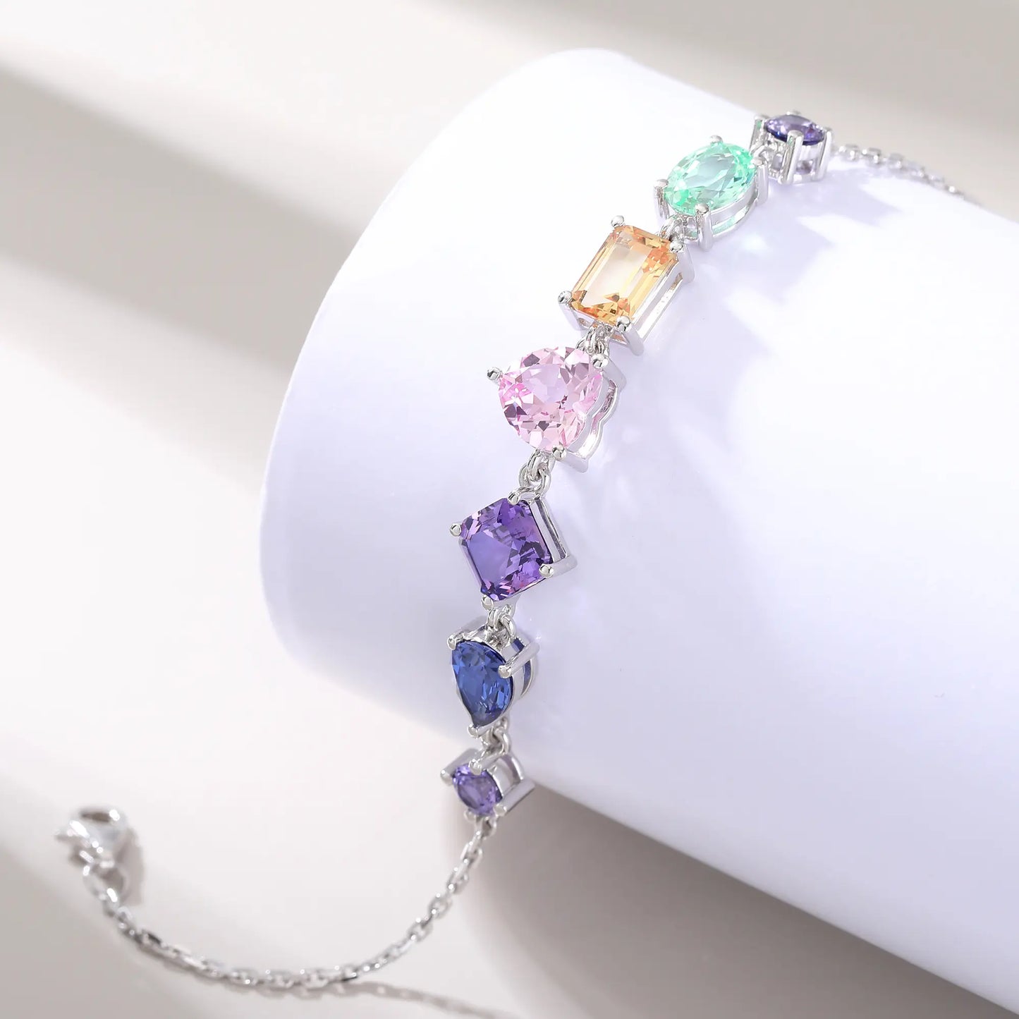 S925 sterling silver chain bracelet featuring seven multi-color and fancy-cut gemstones including heart, pear, emerald, and round shapes.
