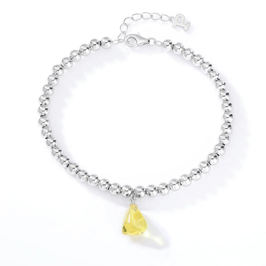 S925 sterling silver beaded bracelet featuring polished round silver beads and a translucent yellow sapphire freeform pendant charm.
