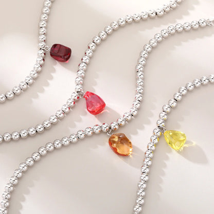 S925 sterling silver beaded bracelet featuring polished round silver beads and a translucent yellow sapphire freeform pendant charm.