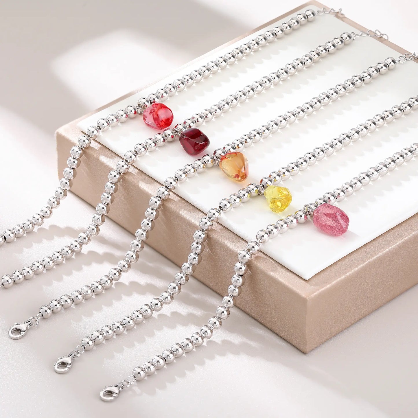 S925 sterling silver beaded bracelet featuring polished round silver beads and a translucent yellow sapphire freeform pendant charm.