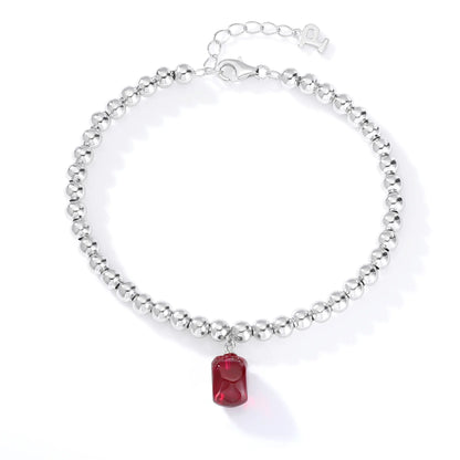 S925 sterling silver beaded bracelet featuring polished round silver beads and a vivid red ruby barrel-cut pendant charm.