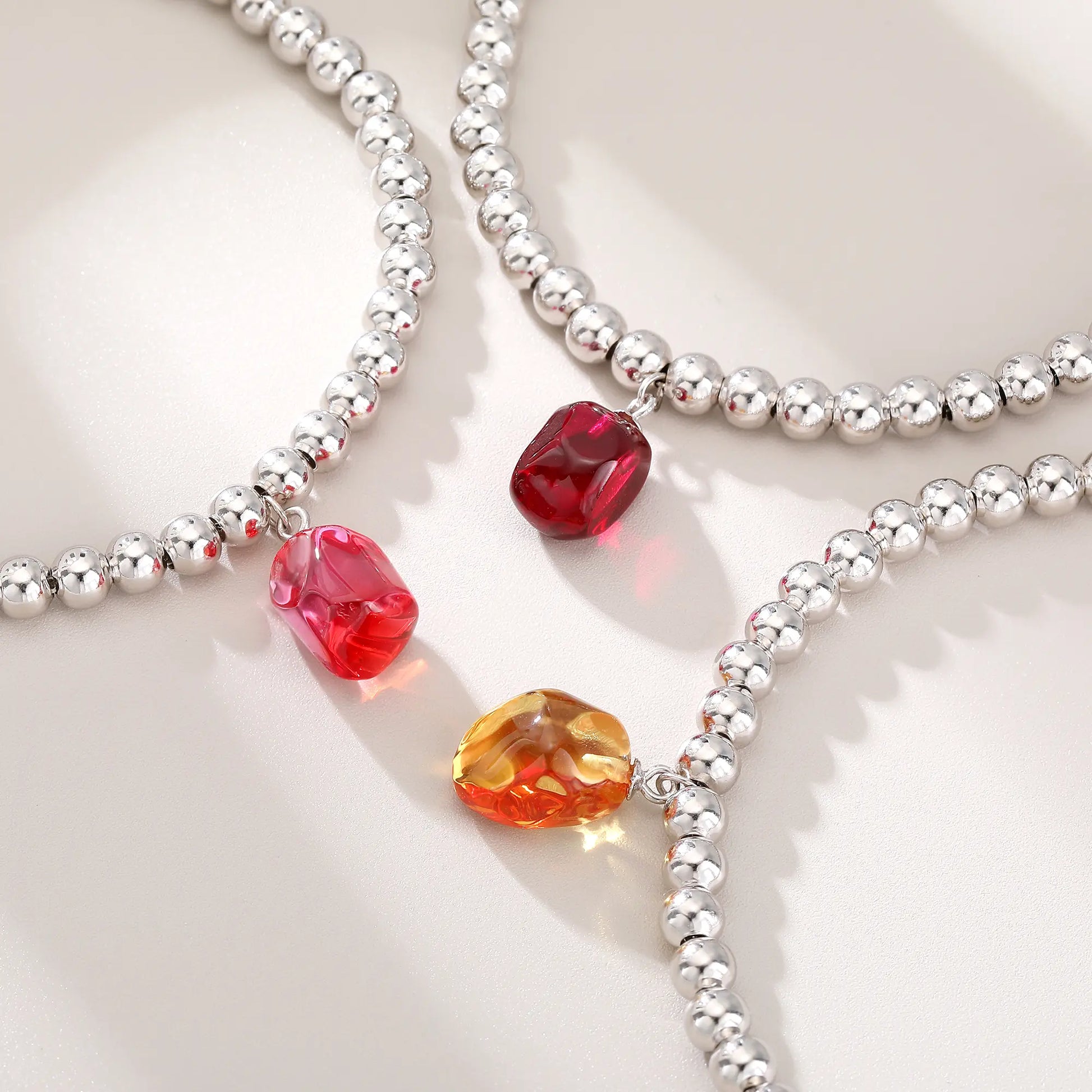 S925 sterling silver beaded bracelet featuring polished round silver beads and a vivid red ruby barrel-cut pendant charm.