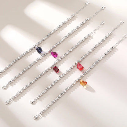 S925 sterling silver beaded bracelet featuring polished round silver beads and a warm champagne sapphire freeform pendant charm.