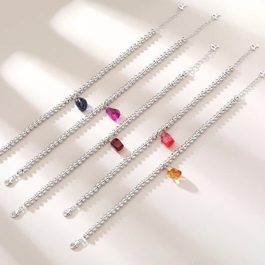 S925 sterling silver beaded bracelet featuring polished round silver beads and a warm champagne sapphire freeform pendant charm.