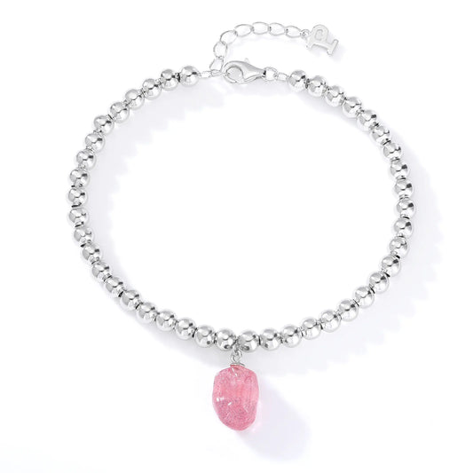 Polished sterling silver spherical bead bracelet featuring a translucent blush-pink freeform gemstone charm with delicate organic textures.