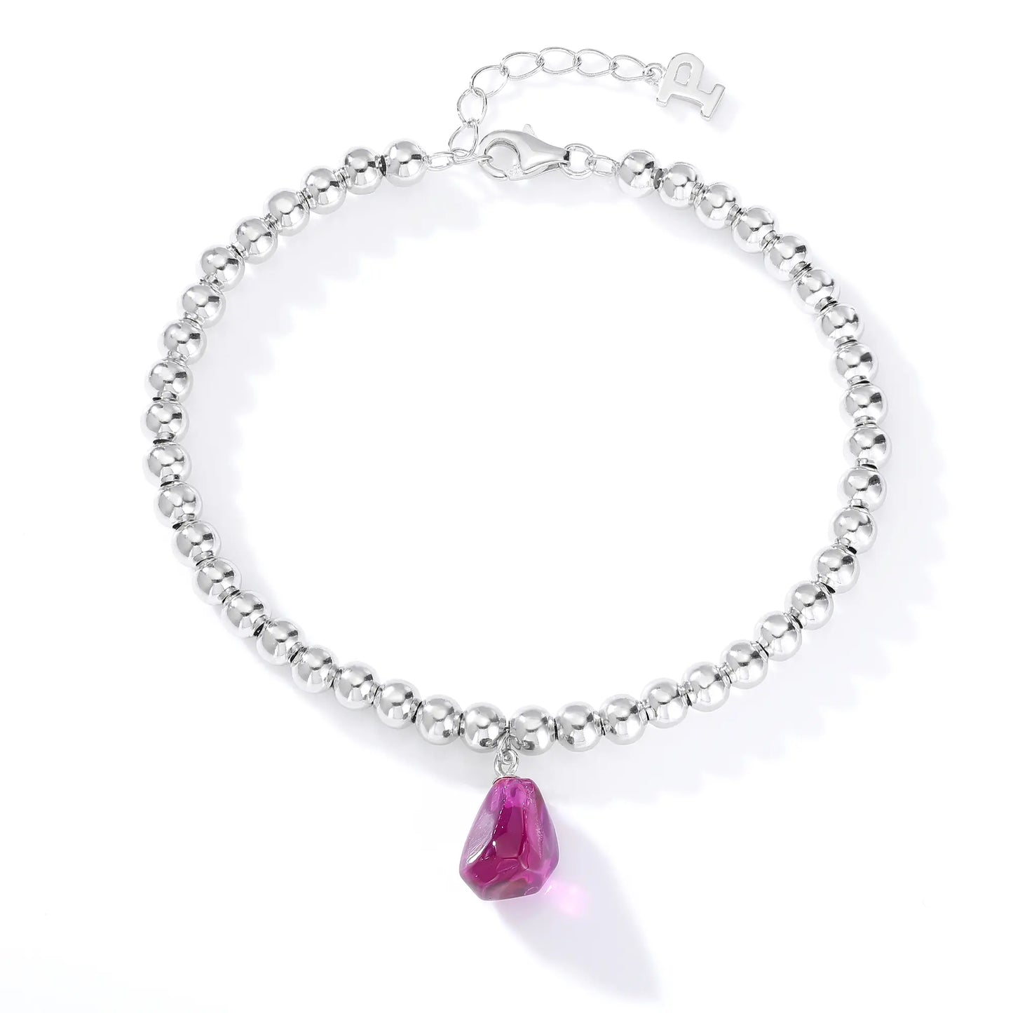 Silver beaded bracelet with a glossy finish featuring a suspended freeform magenta-purple gemstone pendant charm.