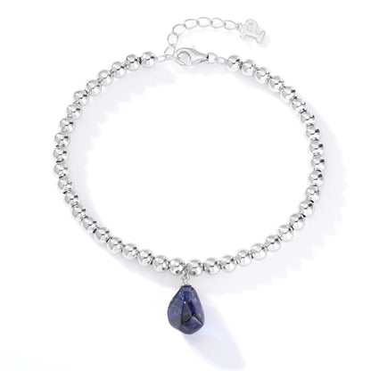 S925 sterling silver spherical bead bracelet featuring a suspended organic freeform charm in a deep royal blue hue.