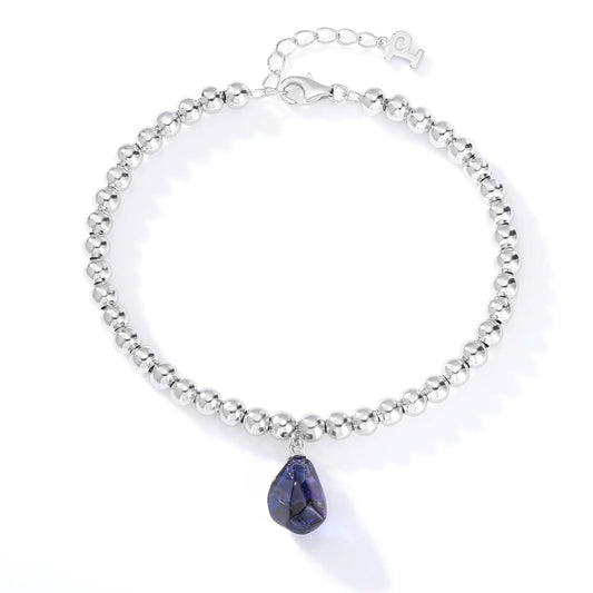 S925 sterling silver spherical bead bracelet featuring a suspended organic freeform charm in a deep royal blue hue.