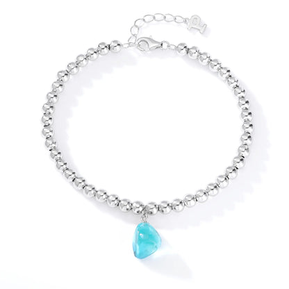 Silver bead strand bracelet featuring a bright turquoise-blue freeform gemstone charm suspended from polished S925 sterling silver spheres.