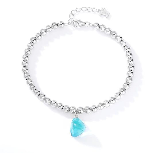 Silver bead strand bracelet featuring a bright turquoise-blue freeform gemstone charm suspended from polished S925 sterling silver spheres.
