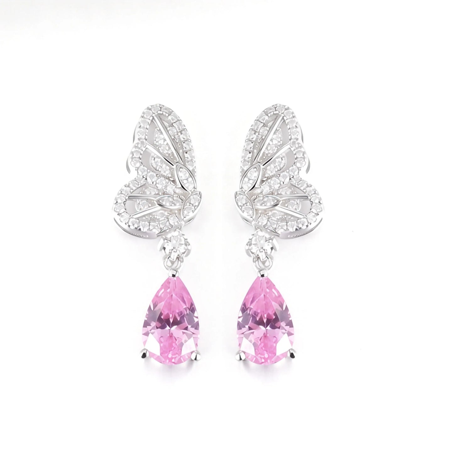 Elegant sterling silver dangle earrings featuring detailed pavé butterfly wings holding vibrant pear-cut pink sapphire stones that catch the light beautifully.