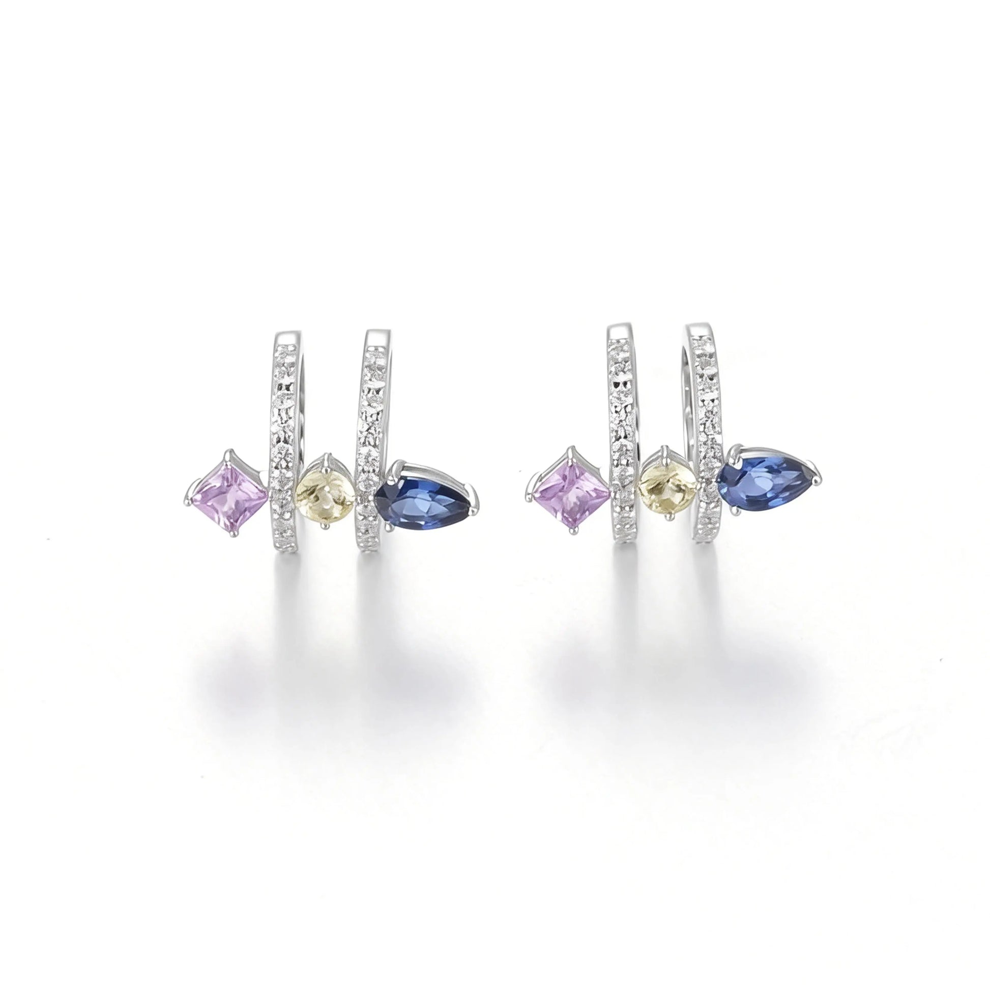 S925 sterling silver double row huggie hoop earrings featuring three geometric gemstones—a blue pear-cut, yellow round-cut, and purple princess-cut stone—with sparkling micro-pavé accents, creating a multi-piercing illusion.