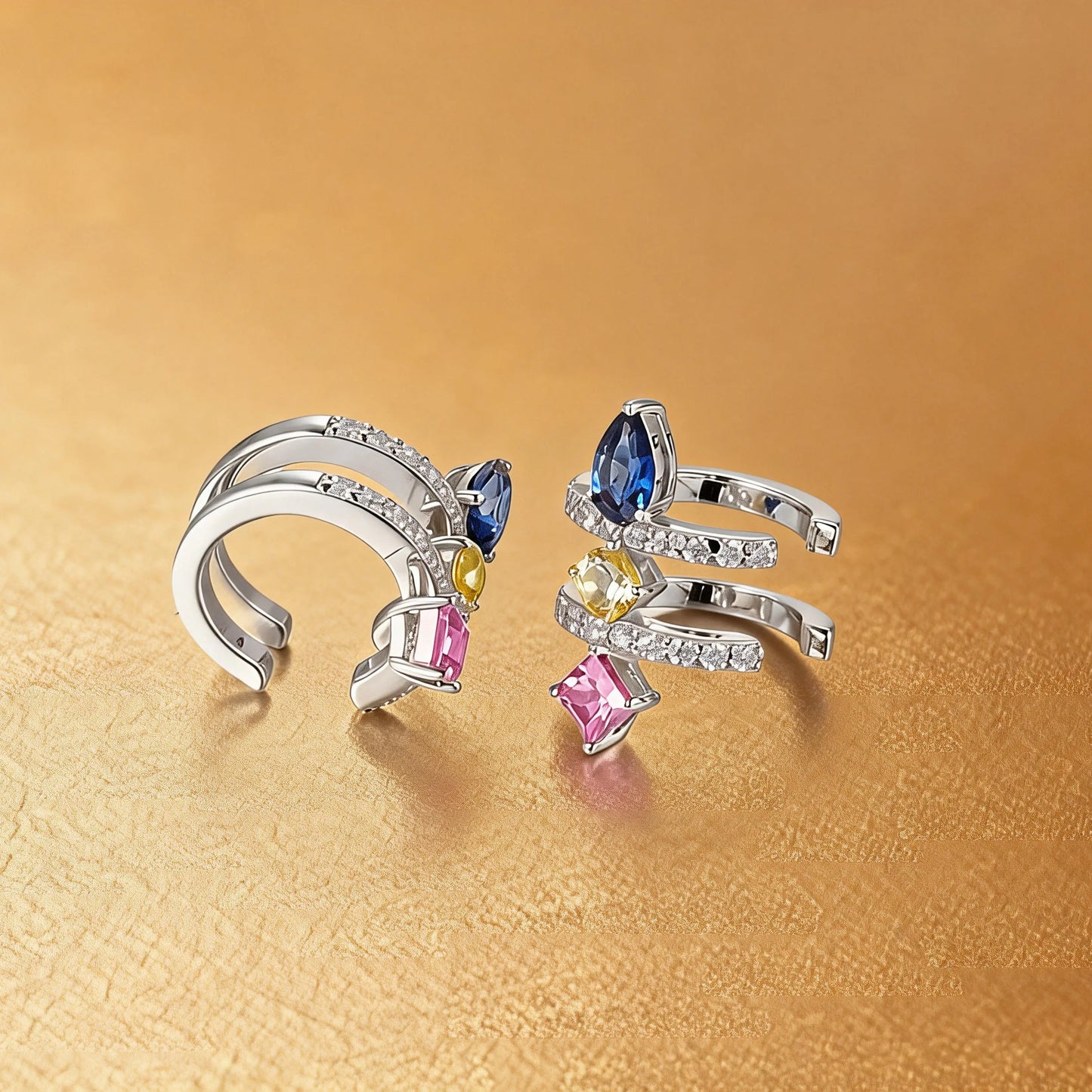 S925 sterling silver double row huggie hoop earrings featuring three geometric gemstones—a blue pear-cut, yellow round-cut, and purple princess-cut stone—with sparkling micro-pavé accents, creating a multi-piercing illusion.