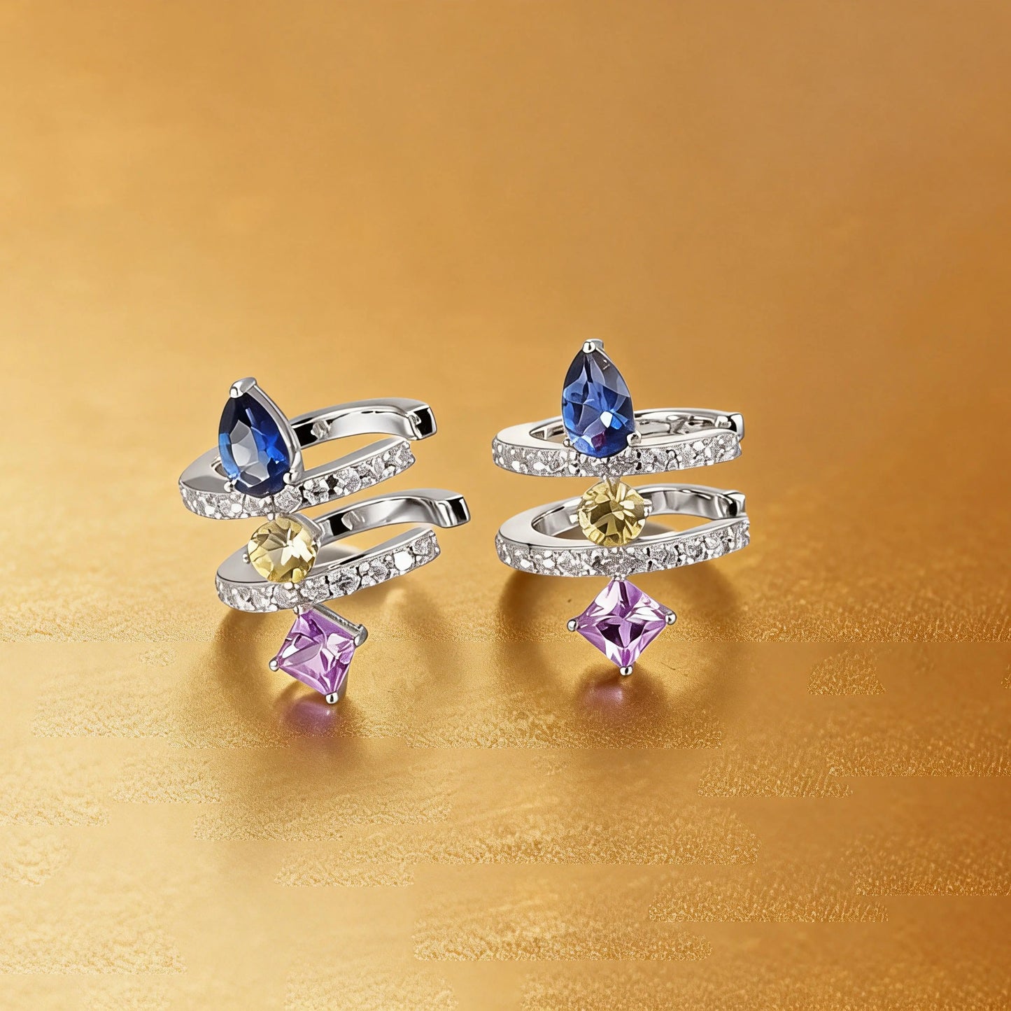 S925 sterling silver double row huggie hoop earrings featuring three geometric gemstones—a blue pear-cut, yellow round-cut, and purple princess-cut stone—with sparkling micro-pavé accents, creating a multi-piercing illusion.