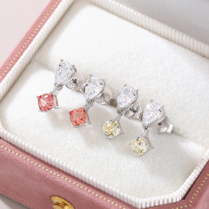 S925 sterling silver drop earrings featuring a sparkling white pear-cut moissanite at the post, dangling a square cushion-cut pink sapphire suspended by a minimalist geometric silver loop.