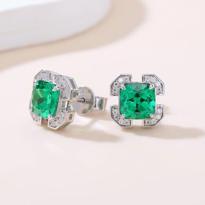 S925 sterling silver geometric stud earrings featuring a square cushion-cut vibrant green lab-grown emerald surrounded by an octagonal frame with pavé CZ accents.