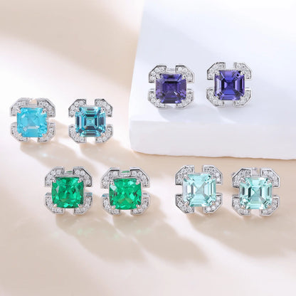 S925 sterling silver geometric stud earrings featuring a square cushion-cut vibrant green lab-grown emerald surrounded by an octagonal frame with pavé CZ accents.