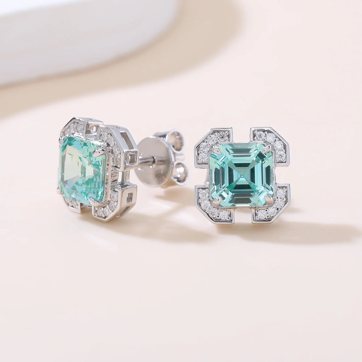 S925 sterling silver geometric stud earrings featuring a square Asscher-cut mint green spinel surrounded by an octagonal frame with pavé moissanite accents.