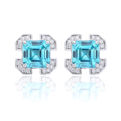 S925 sterling silver geometric stud earrings featuring a square Asscher-cut blue topaz surrounded by an octagonal frame with pavé moissanite accents.