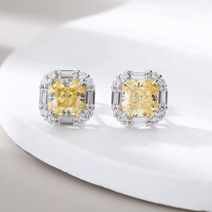 Cushion crushed ice cut canary yellow moissanite stud earrings featuring baguette and round moissanite halo setting.