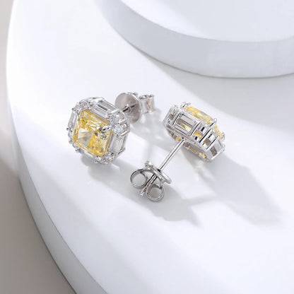 Cushion crushed ice cut canary yellow moissanite stud earrings featuring baguette and round moissanite halo setting.