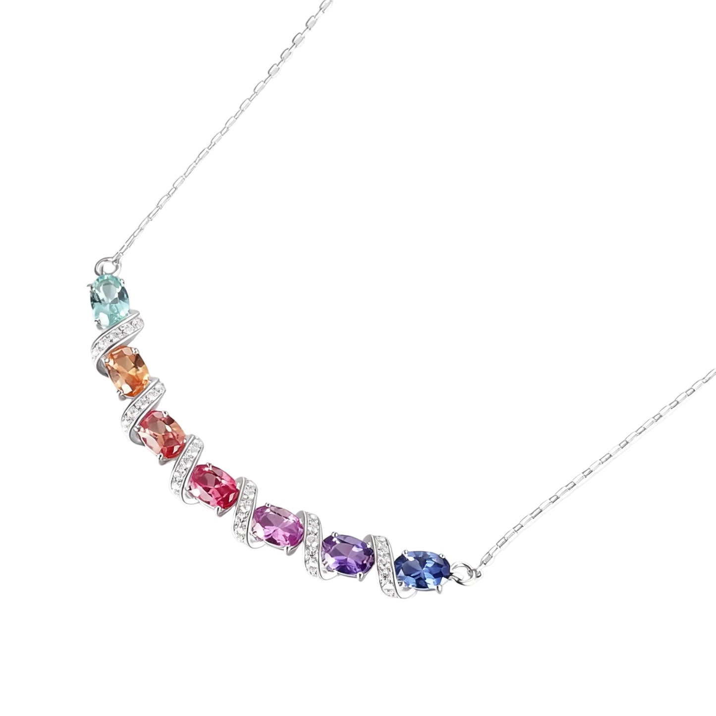 A curved rainbow pendant necklace featuring seven oval cut multi-color sapphires separated by diamond-encrusted silver swirl links, set against a crisp white background.