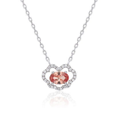 A sterling silver chain necklace featuring a traditional Chinese auspicious Ruyi cloud pendant, encrusted with pavé accents and centered with an oval-cut padparadscha sapphire.