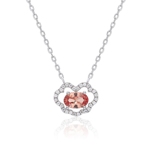 A sterling silver chain necklace featuring a traditional Chinese auspicious Ruyi cloud pendant, encrusted with pavé accents and centered with an oval-cut padparadscha sapphire.