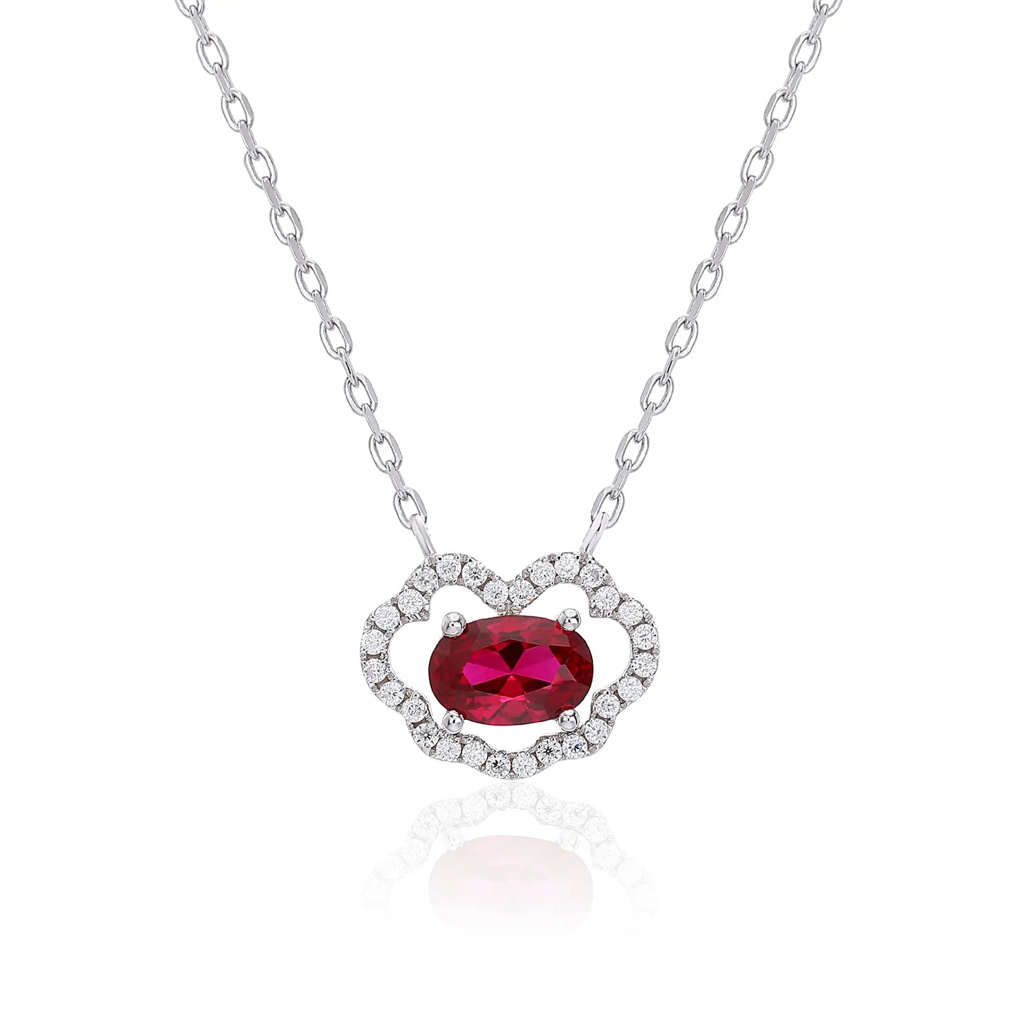 A sterling silver chain necklace featuring a traditional Chinese auspicious Ruyi cloud pendant, encrusted with pavé accents and centered with a vibrant oval-cut red ruby gemstone.