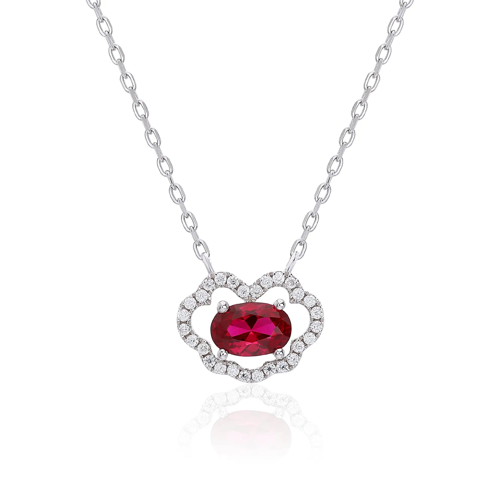 A sterling silver chain necklace featuring a traditional Chinese auspicious Ruyi cloud pendant, encrusted with pavé accents and centered with a vibrant oval-cut red ruby gemstone.