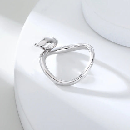 A sterling silver solitaire ring featuring a brilliant marquise-cut white moissanite stone, nestled within a modern fluid bypass twisted wave band.