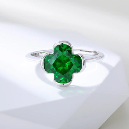 S925 sterling silver ring featuring a single clover-cut vibrant green lab-grown emerald set in a sleek bezel mounting.