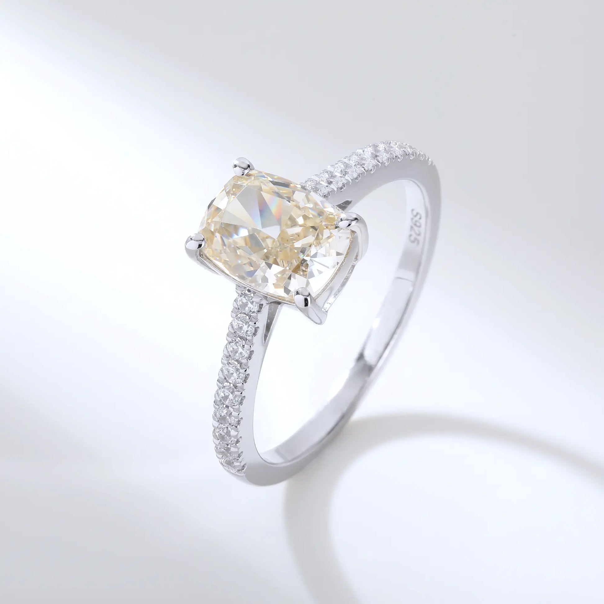 S925 sterling silver ring featuring a warm champagne elongated cushion-cut moissanite center stone on a brilliant sparkling moissanite wedding band.