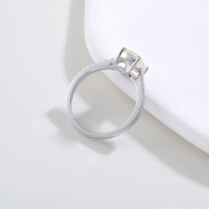 S925 sterling silver ring featuring a warm champagne elongated cushion-cut moissanite center stone on a brilliant sparkling moissanite wedding band.