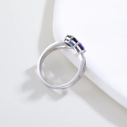 S925 sterling silver criss-cross ring with pear-cut royal blue and lavender sapphires forming a butterfly with a sparkling accent at the center.