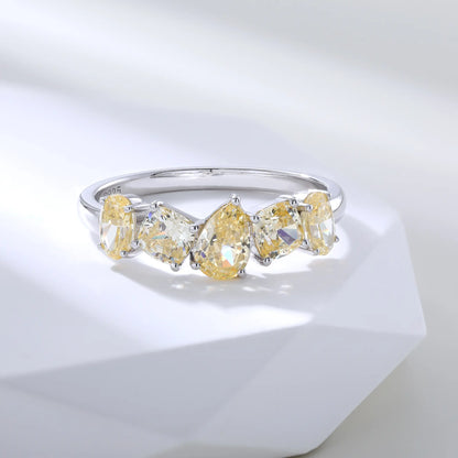 S925 sterling silver five-stone ring featuring fancy multi-shape yellow moissanites including pear, cushion, and oval cuts in a contour band.