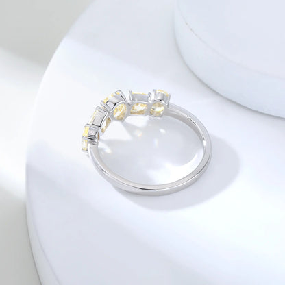 S925 sterling silver five-stone ring featuring fancy multi-shape yellow moissanites including pear, cushion, and oval cuts in a contour band.