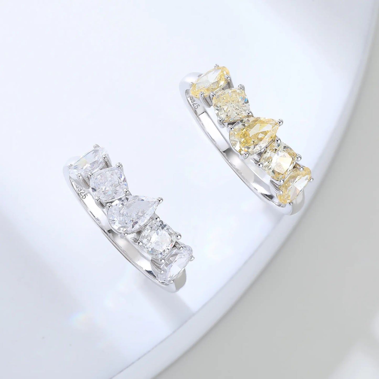 S925 sterling silver five-stone ring featuring fancy multi-shape yellow moissanites including pear, cushion, and oval cuts in a contour band.