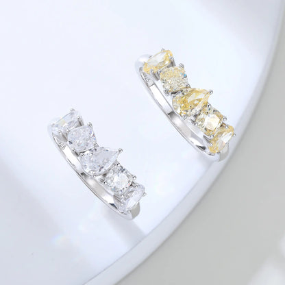 S925 sterling silver five-stone ring featuring fancy multi-shape yellow moissanites including pear, cushion, and oval cuts in a contour band.