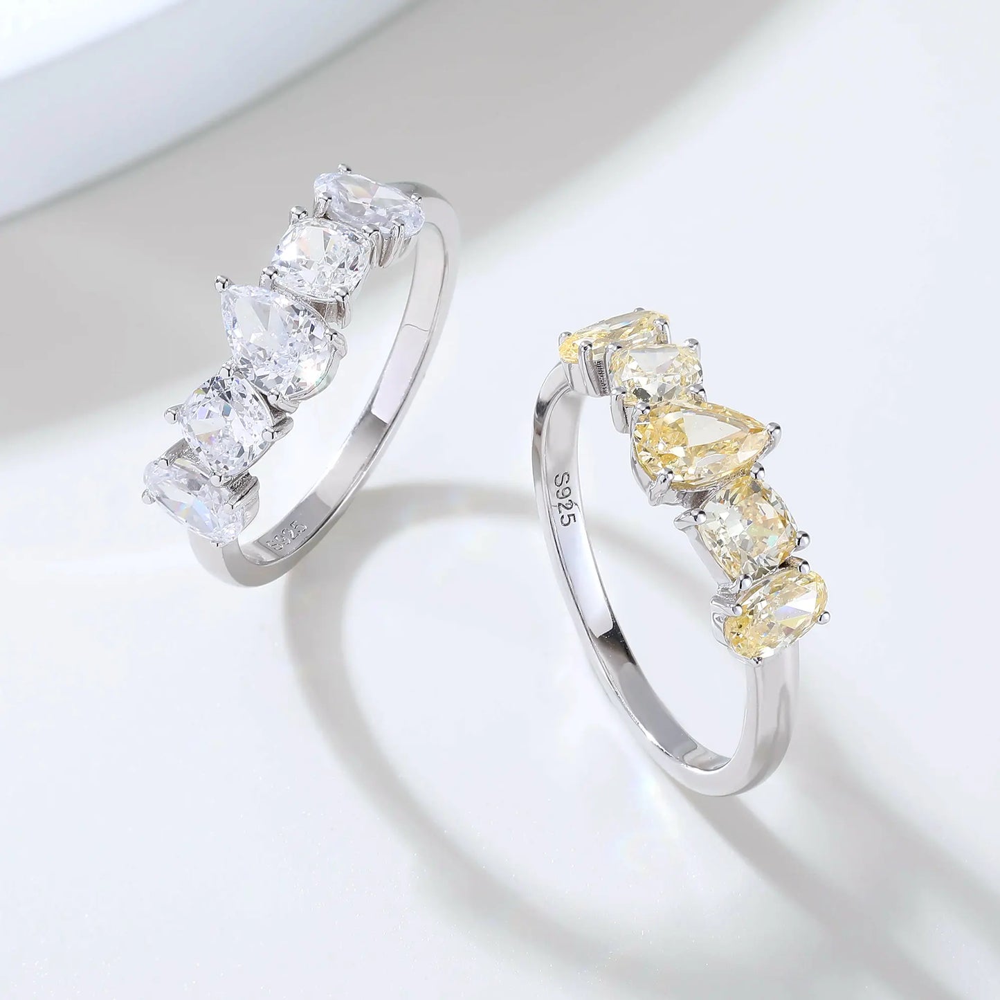 S925 sterling silver five-stone ring featuring fancy multi-shape yellow moissanites including pear, cushion, and oval cuts in a contour band.
