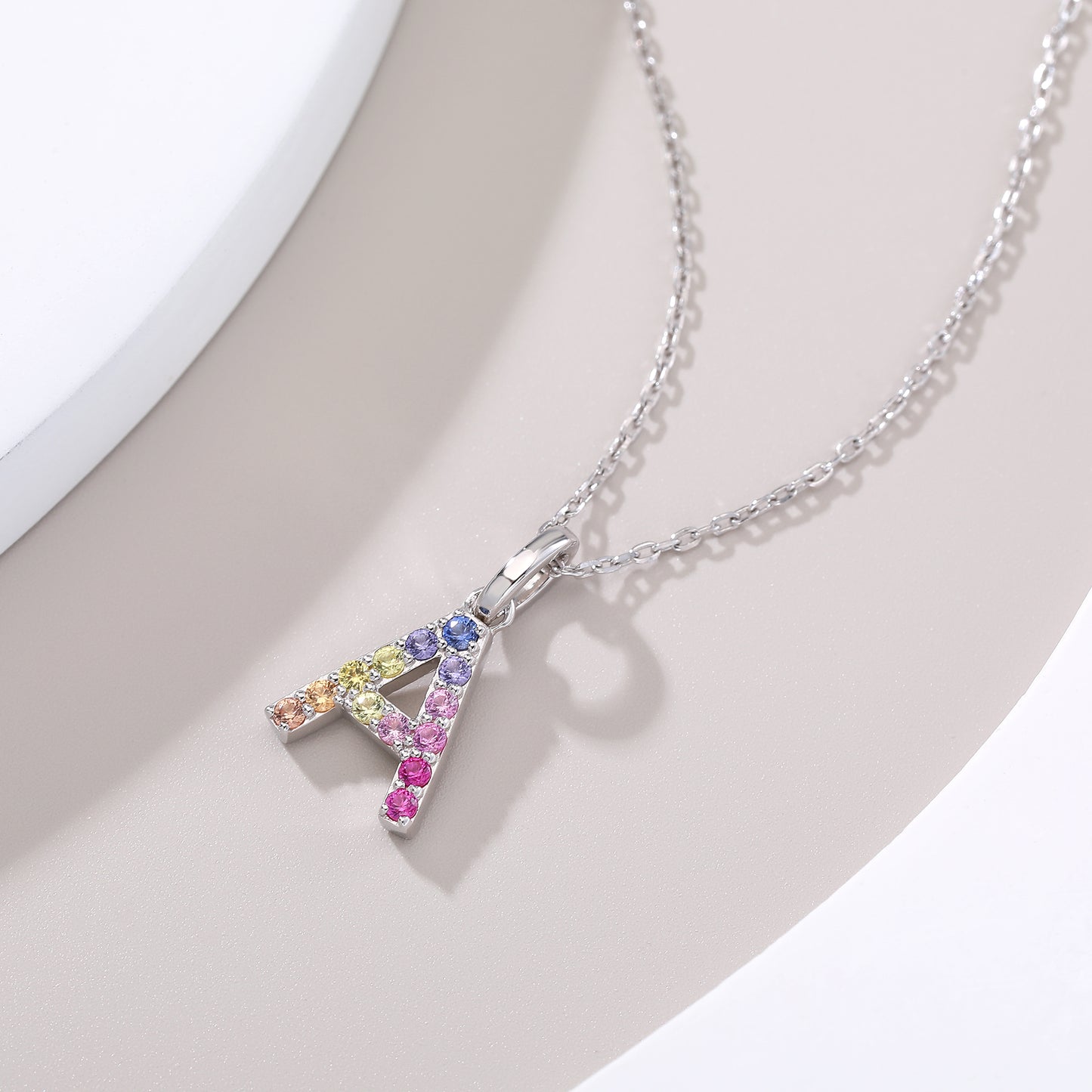Vibrant multi-color lab-grown sapphire letter A pendant on a sterling silver chain necklace