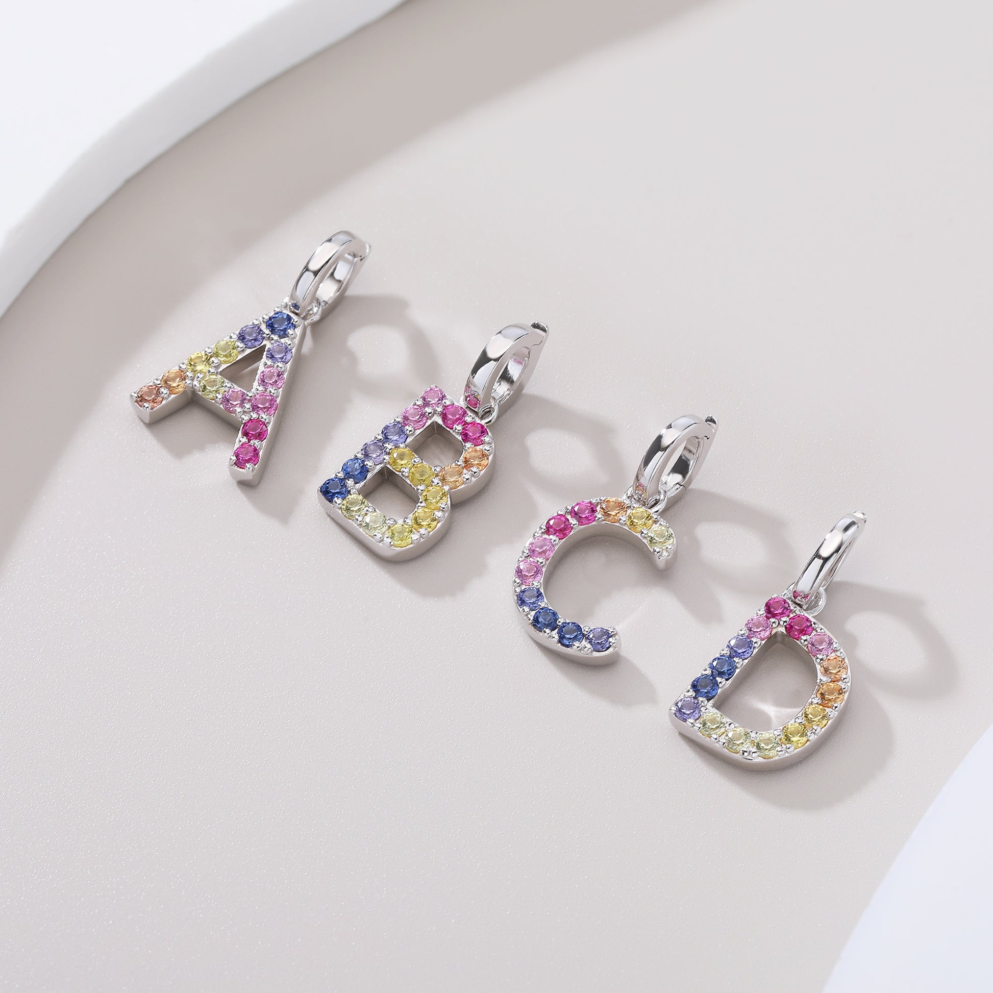 Vibrant multi-color lab-grown sapphire letter A pendant on a sterling silver chain necklace