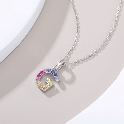 A delicate sterling silver necklace displaying a capital letter G charm micro-pave set with a shifting rainbow curve of lab-grown multi-color sapphires.