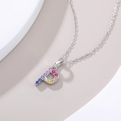 A delicate sterling silver cable chain necklace showcasing an uppercase letter P pendant precision-set with a vibrant rainbow gradient of round multi-color lab sapphires.